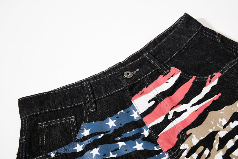Close-up of front waistband and flag graphic on black denim jeans