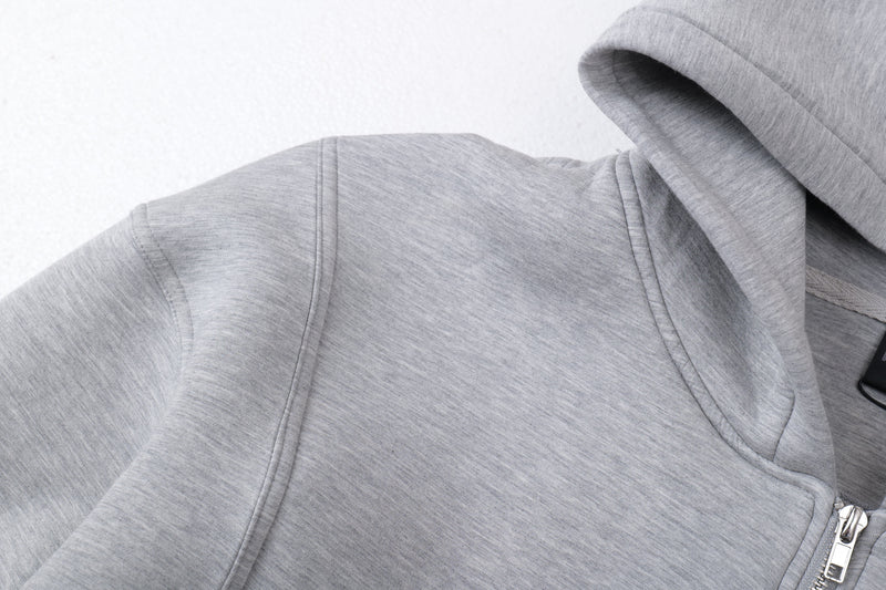 Close-up of light gray hoodie shoulder and hood seam detail