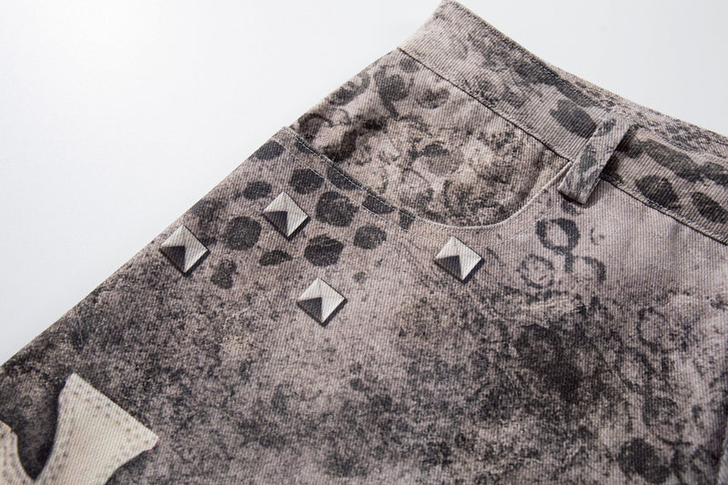Close-up of upper front side showing studded detail and faded grunge wash on denim shorts
