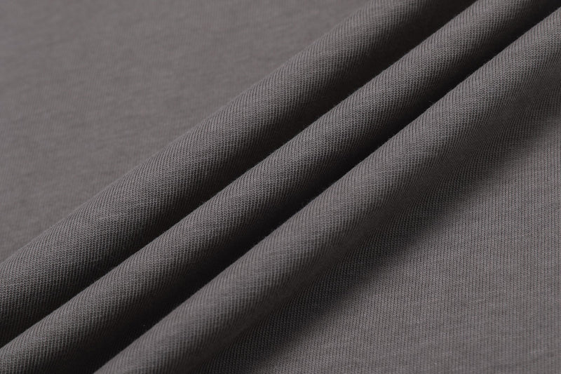 Close-up of gray colorblock T-shirt fabric with diagonal paneling and soft knit texture