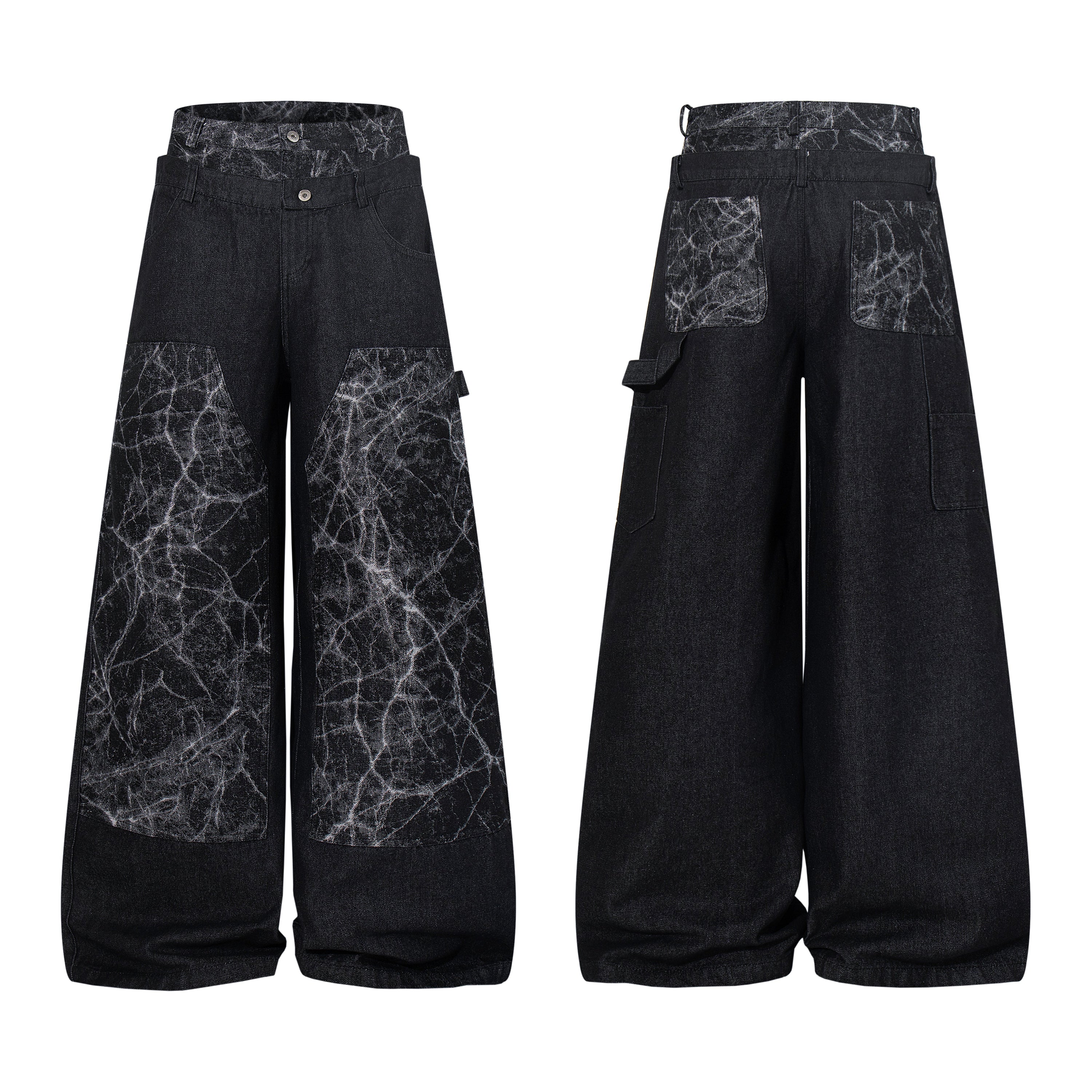 Front and back view of black wide-leg denim pants with cracked white texture contrast panels and layered waistband