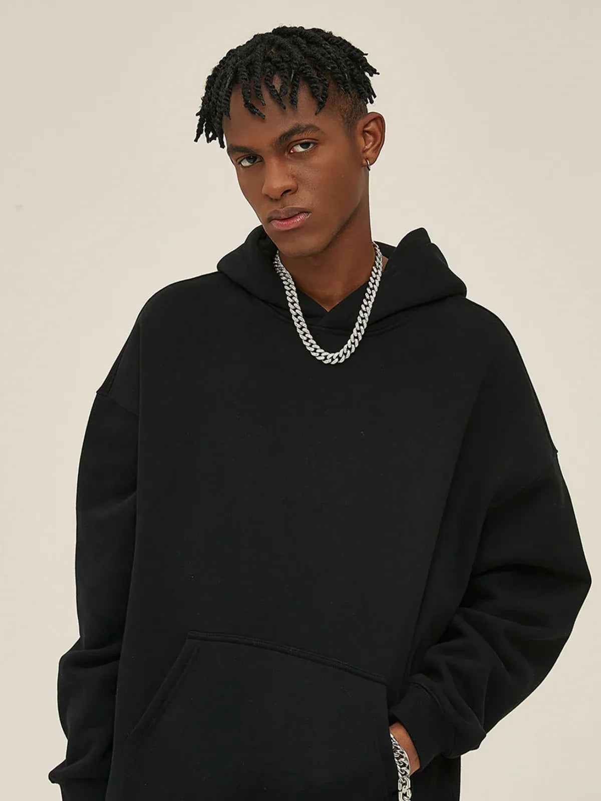 A person wearing the Custom Anime Character Black Hoodie—Personalized 350GSM 100% Cotton Pullover—paired with a silver chain, stands against a plain light background and looks at the camera.