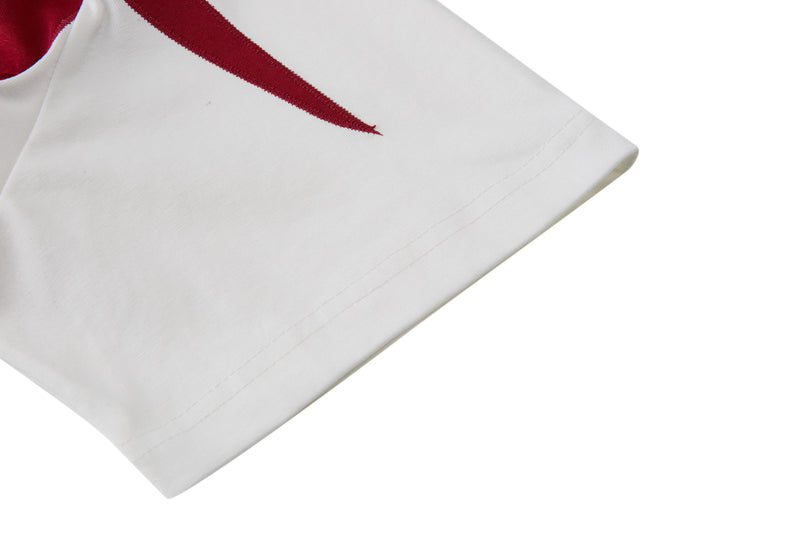 White retro football jersey sleeve with burgundy trim and clean stitched hem on a minimalist background