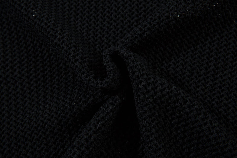 Black knit cuff detail on mesh track jacket close-up