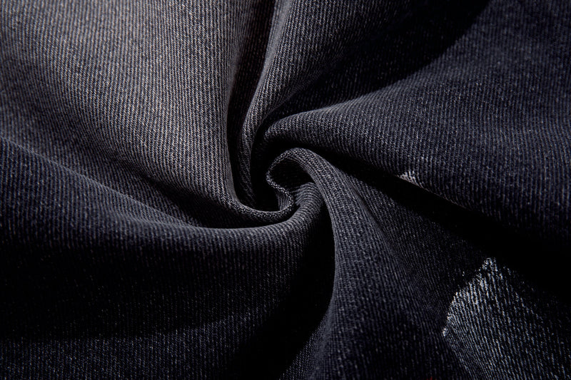 Close-up of dark wash denim fabric texture and brushstroke fade