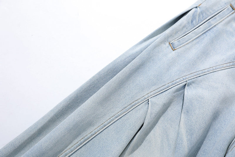 Close-up of side seam and pocket detail on light wash denim wide-leg jeans