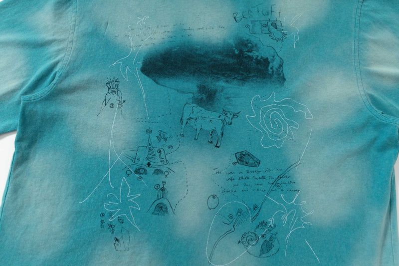 Washed teal T-shirt with abstract sketch graphics and vintage distressed streetwear design across the chest