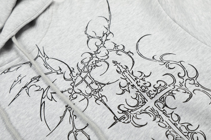 Close-up of light gray hoodie front graphic with black gothic cross design