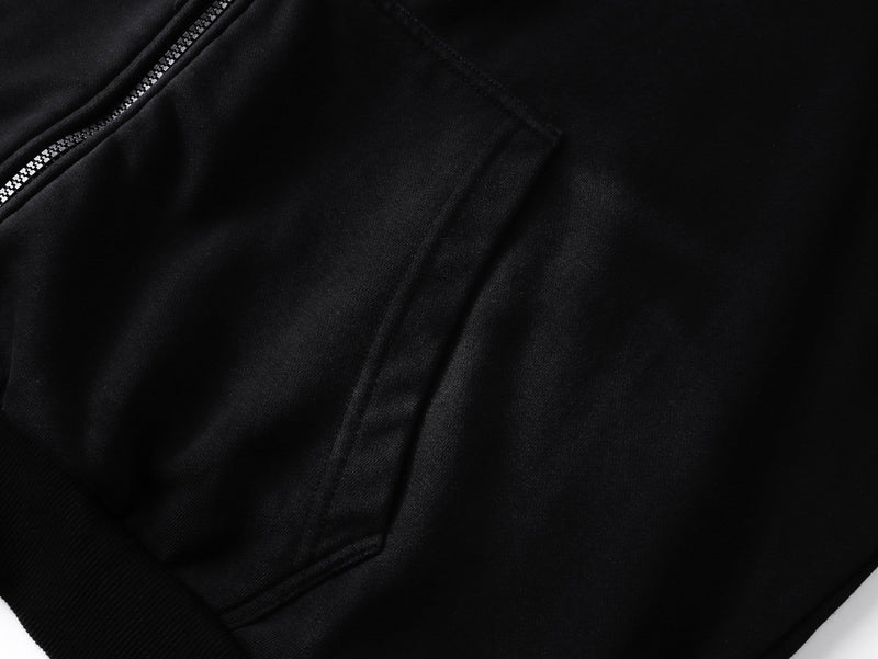 Close-up of black hoodie front pocket area and zipper on matte sweatshirt fabric