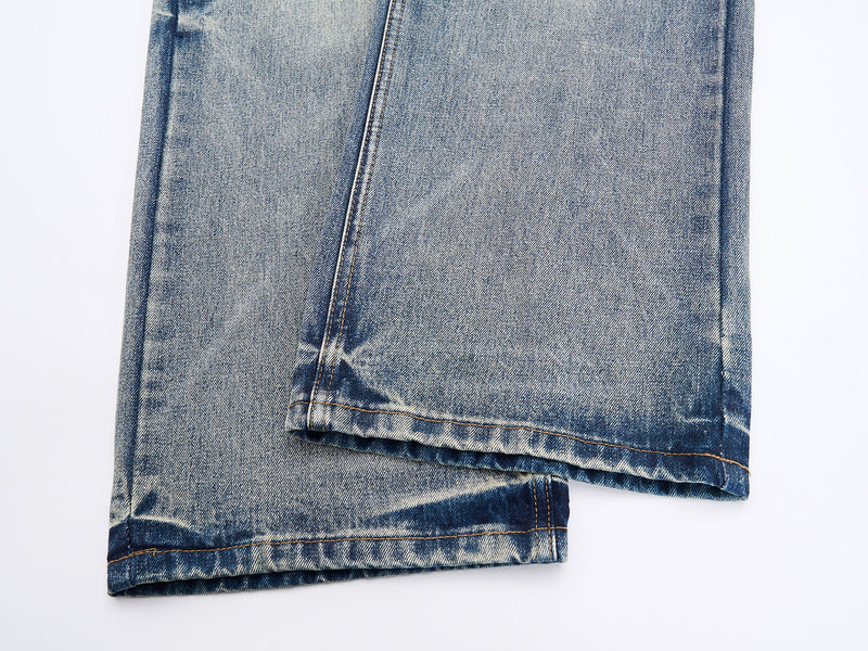 Close-up of hem detail on light-wash wide-leg denim jeans