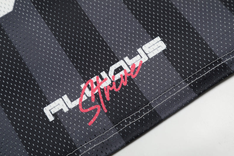 Close-up of black mesh football jersey fabric with white graphic lettering and red 33 streetwear print