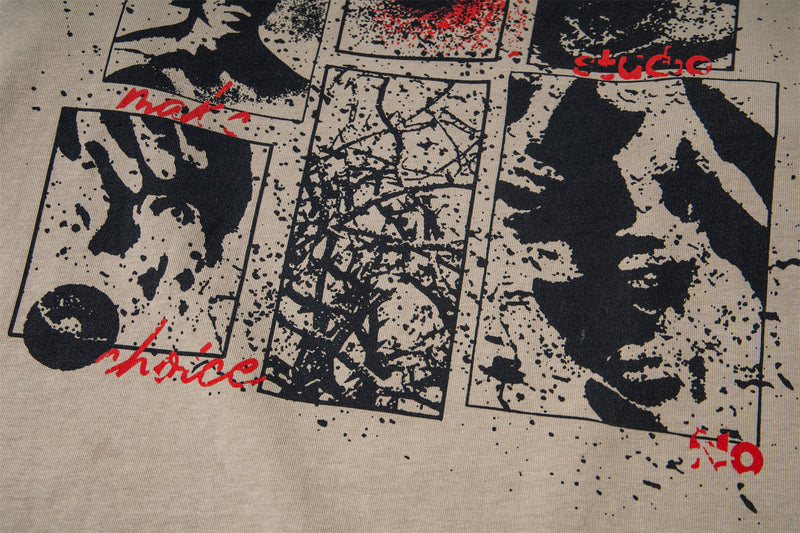 Close-up of printed portrait collage and red accents on beige graphic T-shirt