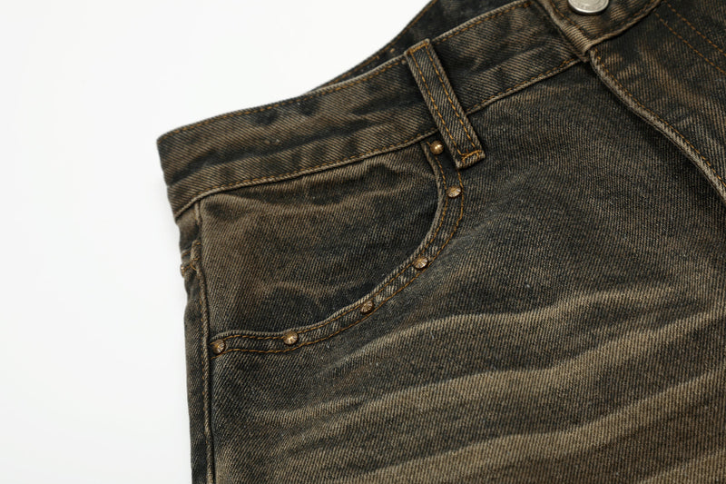 Close-up of rear pocket and side seam on faded dark denim jeans