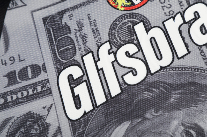 Close-up of a mesh football jersey with dollar bill print and bold white GITSH lettering in streetwear style