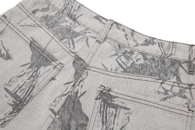 Close-up of the back waistband and pocket seams on printed gray denim