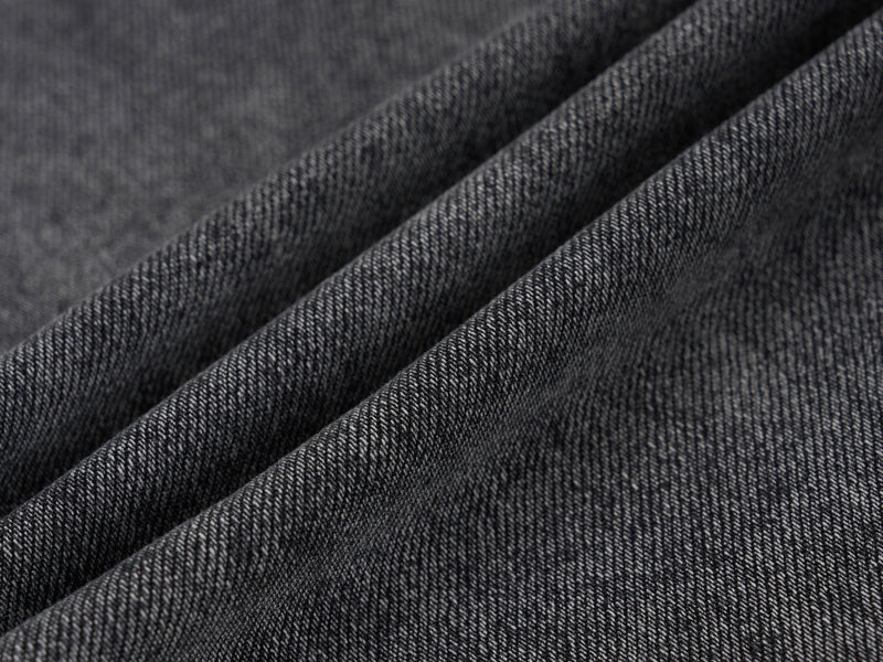 Close-up of grey denim fabric texture with soft folds
