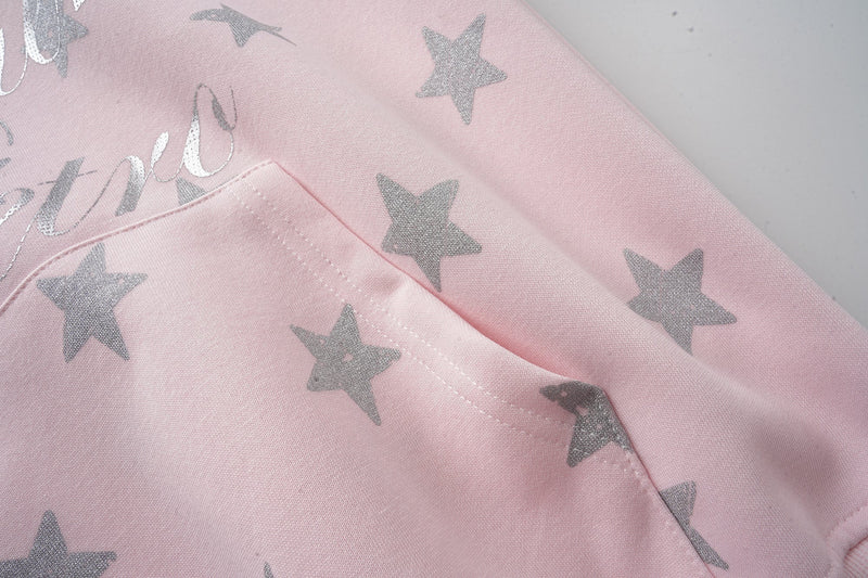 Pink hoodie front close-up with kangaroo pocket and silver stars