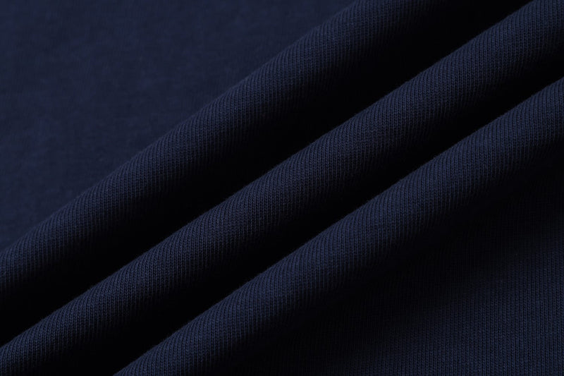 Folded navy knit fabric close-up with soft ribbed texture and diagonal drape