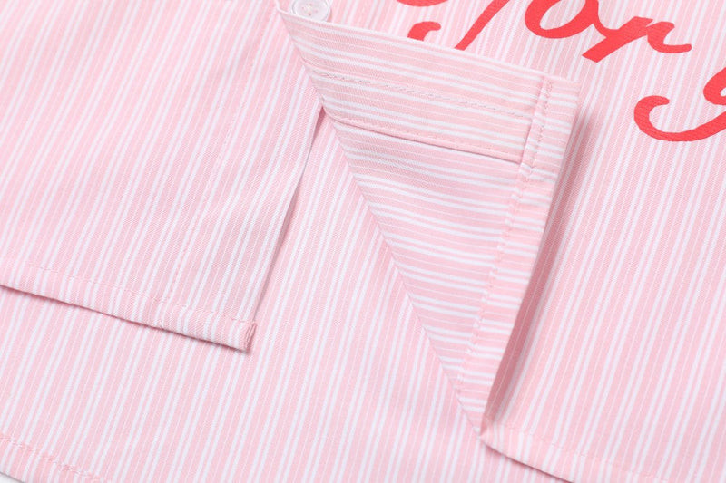 Close-up of pink striped shirt cuff and side seam detail