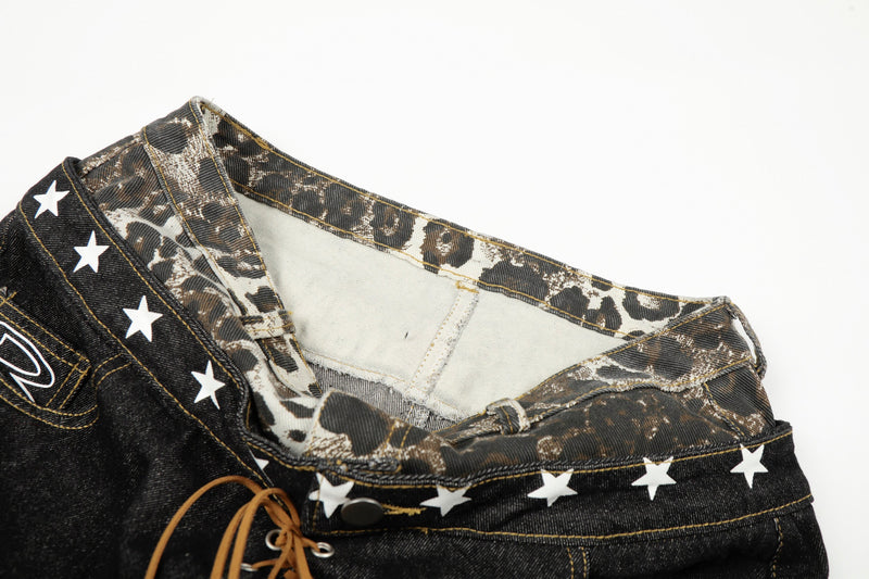 Close-up of the inner waistband and leopard-print denim on black wide-leg jeans