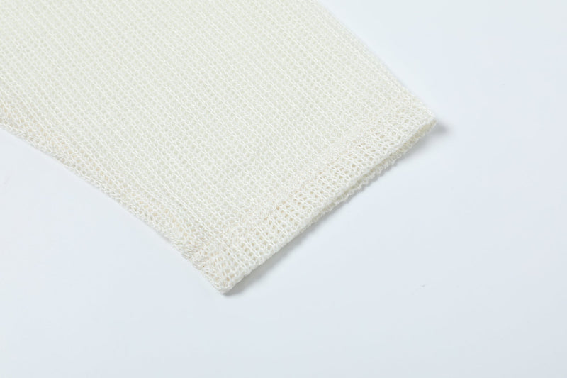 Close-up of cream mesh sleeve cuff with textured knit fabric