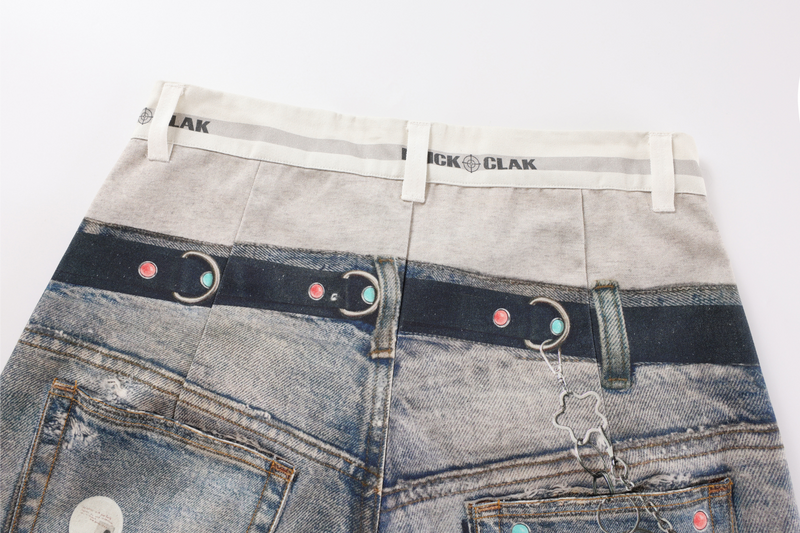 Back waistband of faded patchwork jeans with printed belt graphic and back pockets