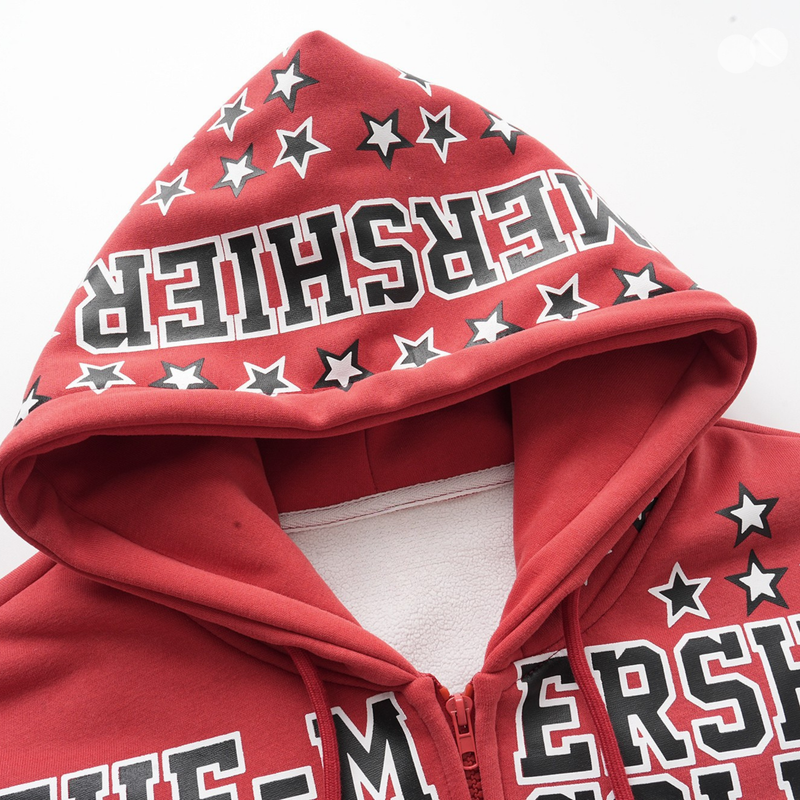 Close-up of red hood with star print and bold MERSHIER lettering