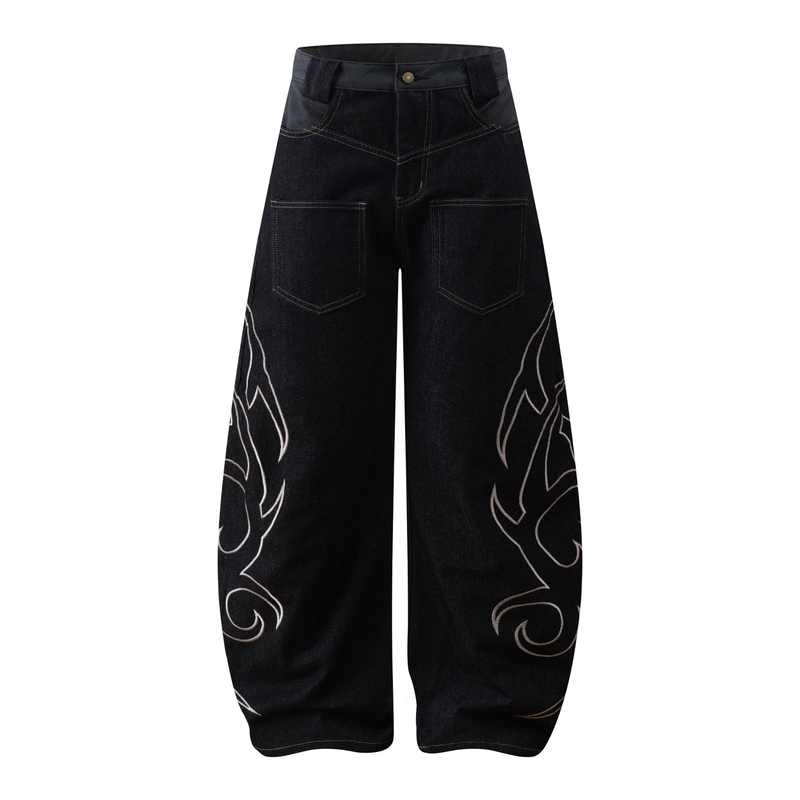 Front view of dark wide-leg denim jeans with tribal embroidery and balloon silhouette