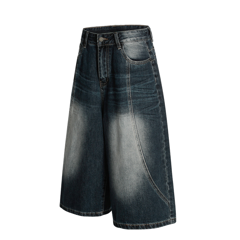 Angled front view of dark washed wide-leg denim shorts with light faded panels and front pockets