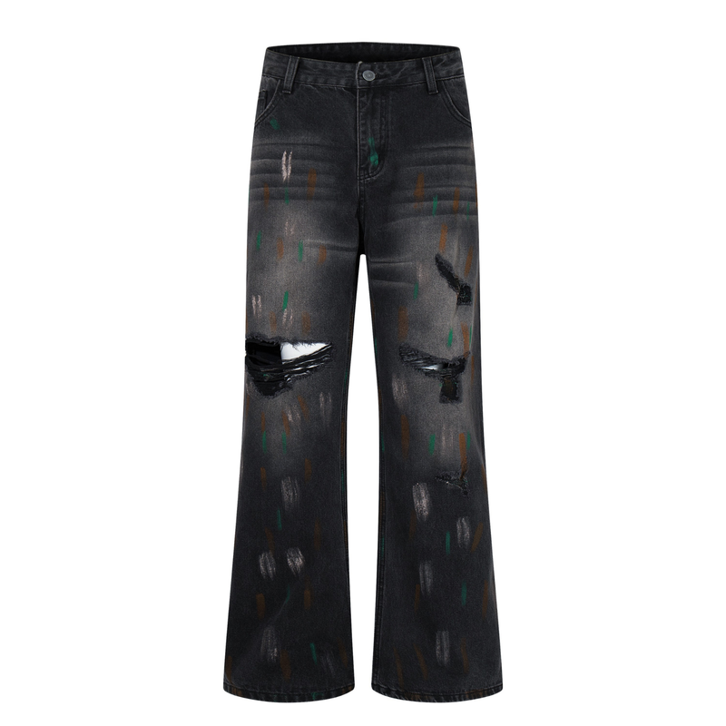 Front view of washed black wide-leg jeans with distressed rips and paint-like streaks