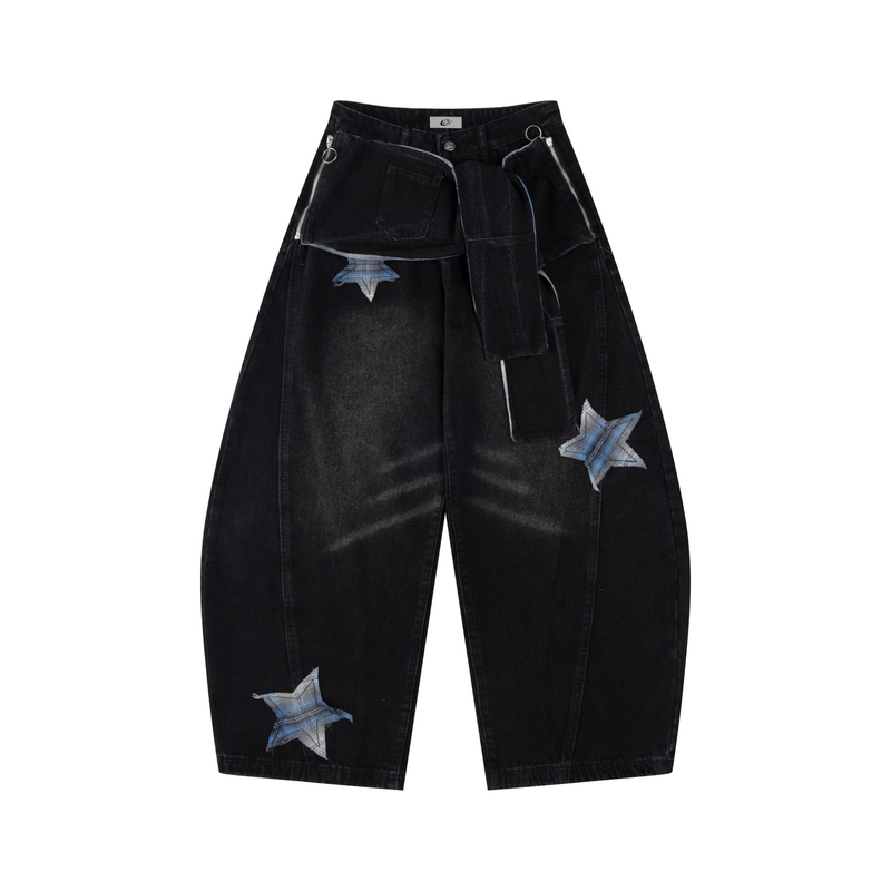 Front view of black wide-leg jeans with star patches, wrap panel, and zip pocket details