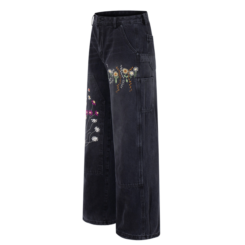 Side view of washed black wide-leg carpenter jeans with floral embroidery and utility pockets