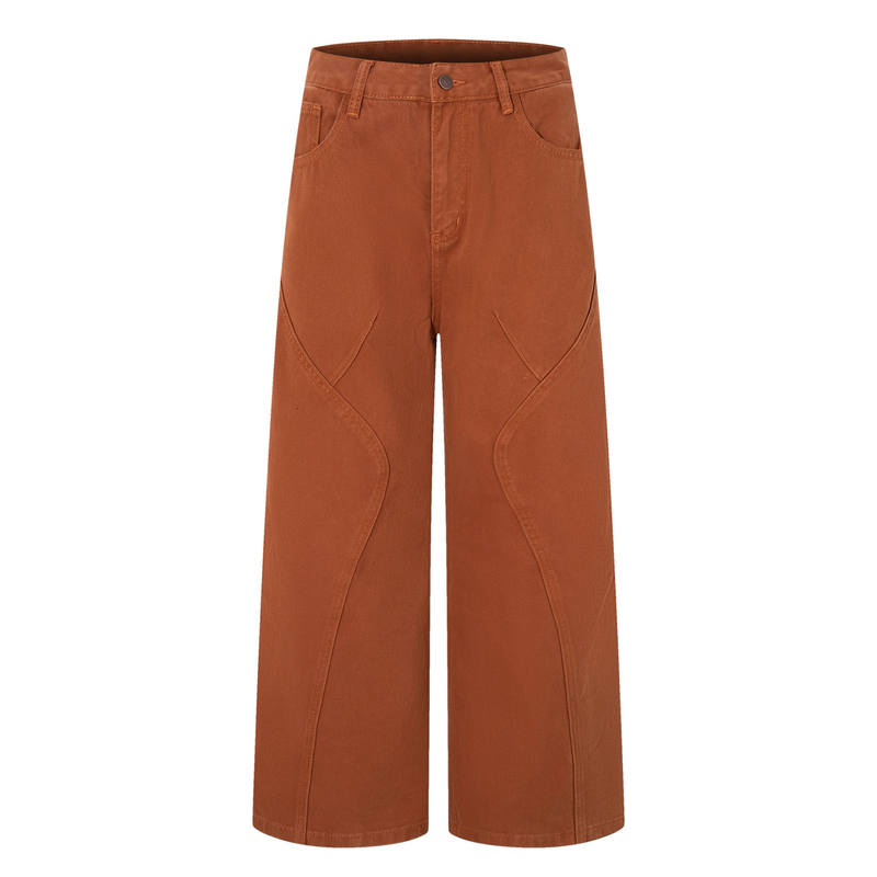 Front view of rust brown wide-leg jeans with curved panel seams and straight waistband