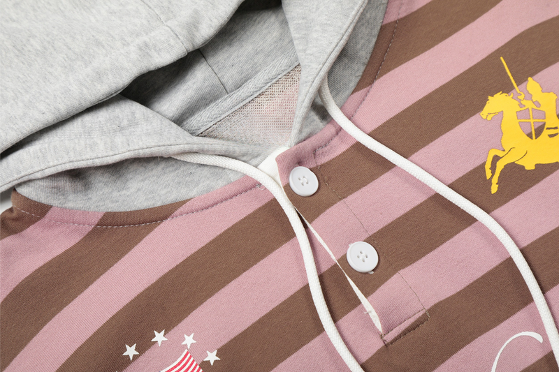 Close-up of hoodie collar, white drawstrings, and striped pink and brown fabric with front buttons