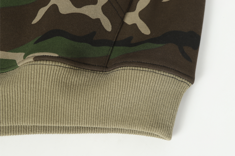 Beige ribbed hem on camo hoodie close-up