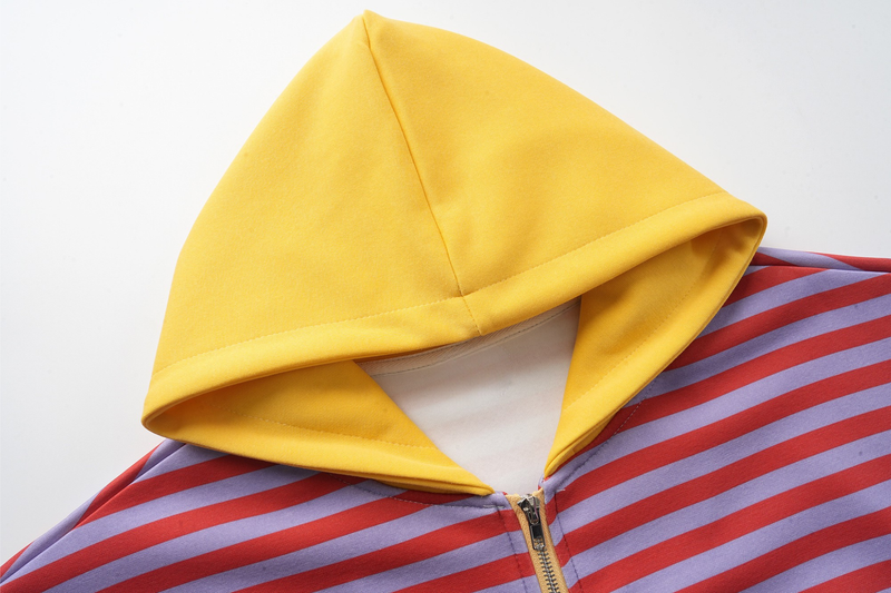 Close-up of yellow hood and top zipper on striped zip-up hoodie