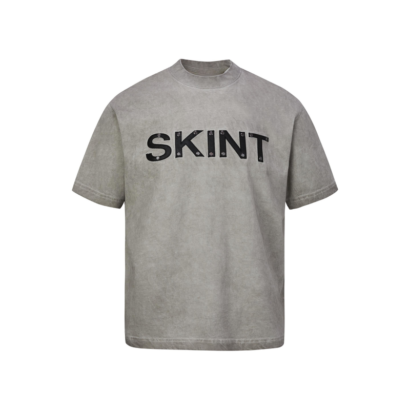 Vintage washed gray SKINT heavyweight cotton tee with rivet detail and oversized black chest lettering