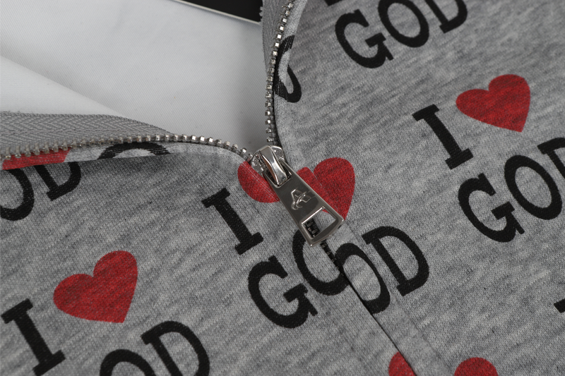 Close-up of gray hoodie zipper with I Love God print