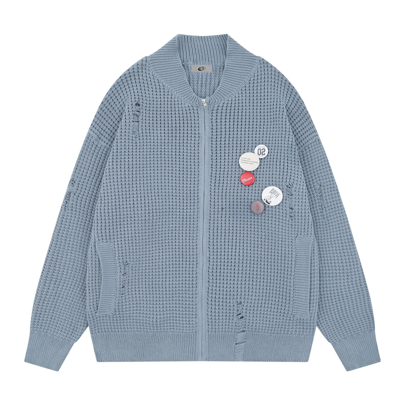 Light blue waffle knit zip cardigan with distressed details and badge pins, front view