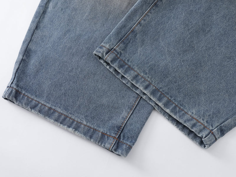Close-up of the jean hem with stitched cuff and worn edge