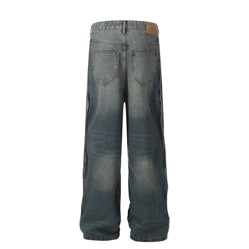 Back view of faded blue wide-leg jeans with patch back pockets and tan logo waistband tab