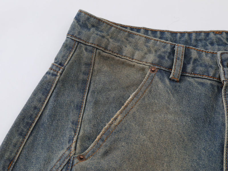 Close-up of the front hip and curved seam on distressed wide-leg jeans