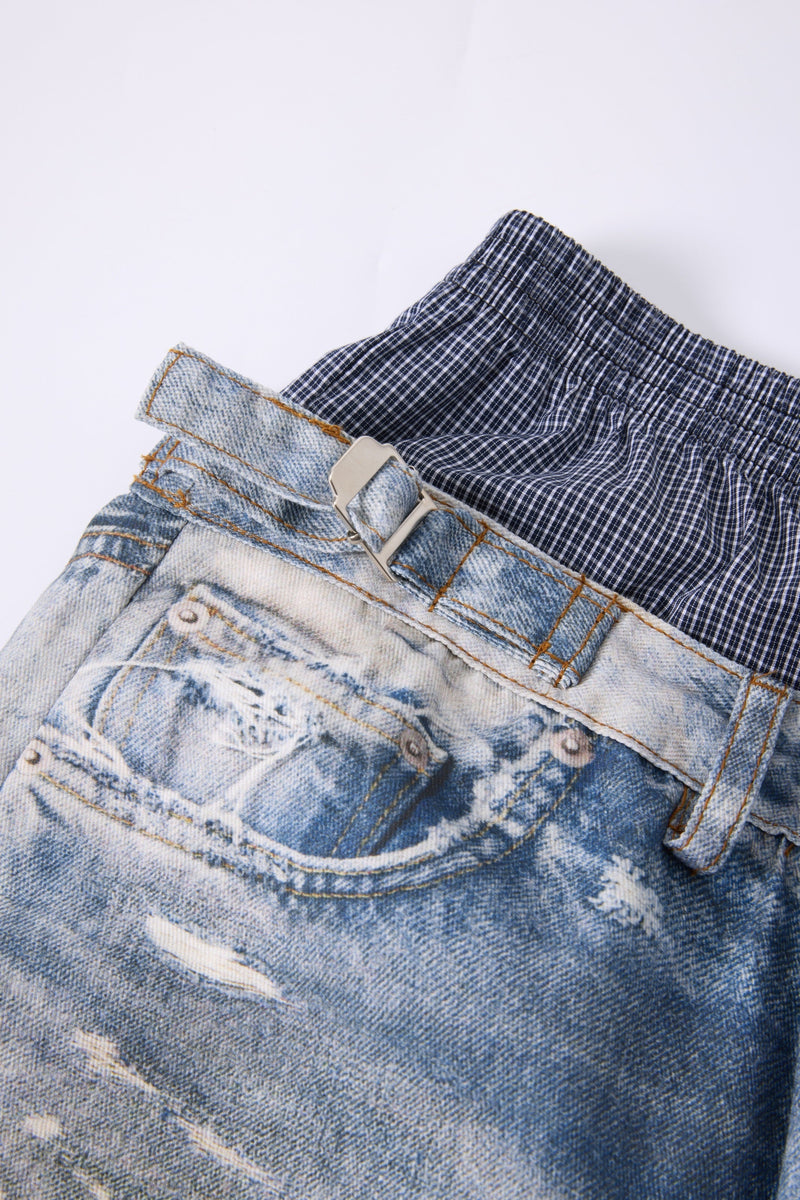 Close-up of back pocket and metal buckle on light wash layered-waist jeans