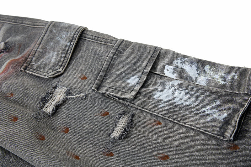Close-up of side cargo pockets and distressed patches on gray denim pants