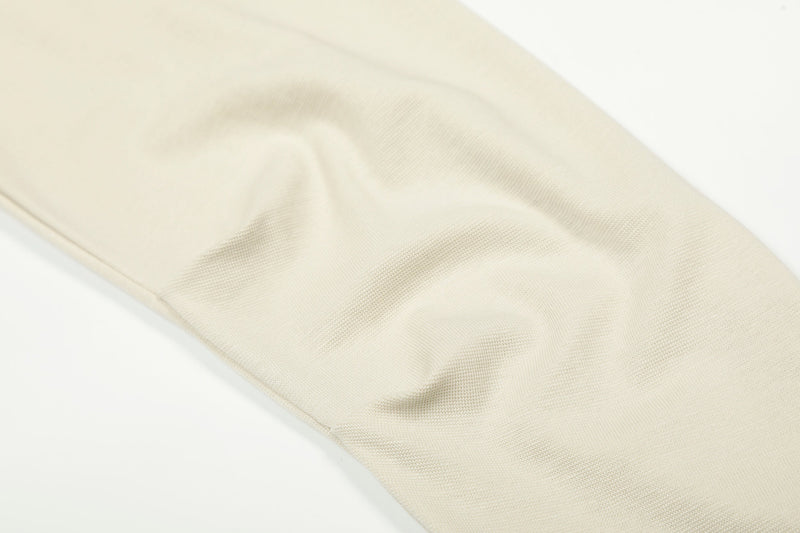 Cream sleeve close-up showing smooth knit fabric texture