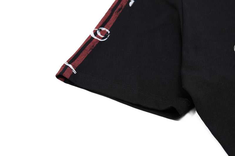 Black men's polo shirt with red striped sleeve detail and white music graphic print on the hem