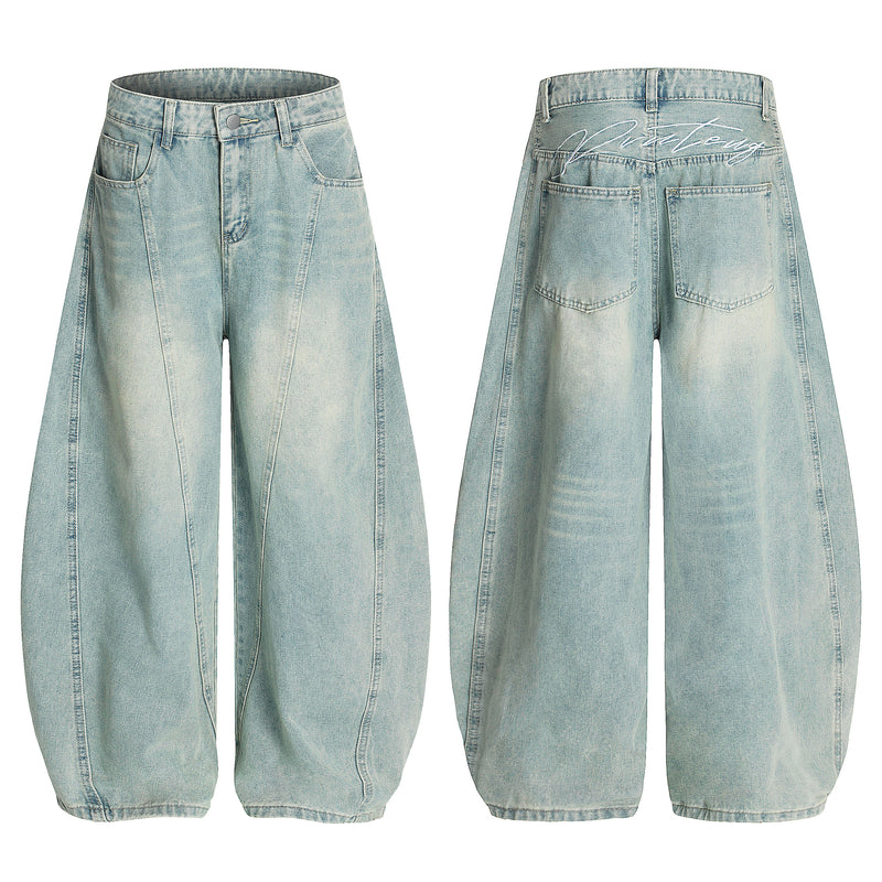 Front and back view of light blue vintage wash curved barrel wide-leg denim jeans with diagonal seam detailing