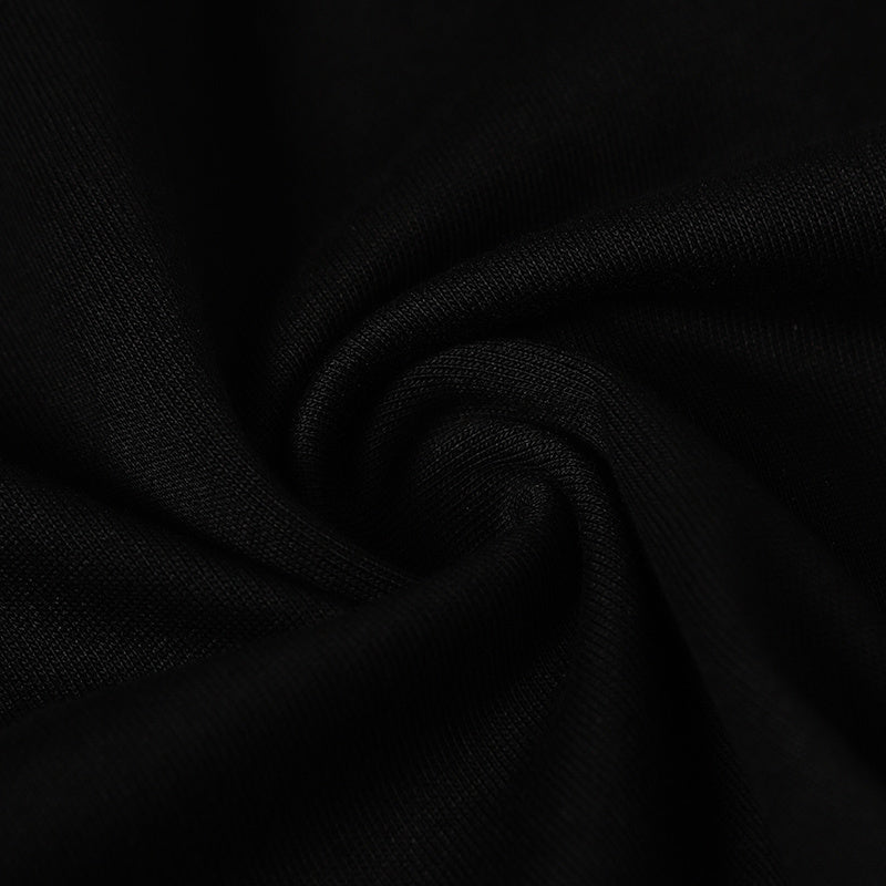Close-up of black cotton fabric with a soft ribbed texture and subtle drape for a streetwear tee