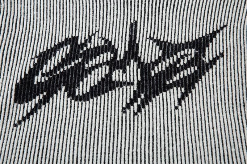 Close-up of lightning graphic on white ribbed knit sweater