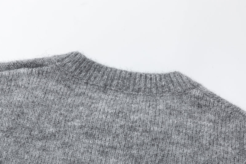 Close-up of gray knit cardigan shoulder and crew neck ribbed trim